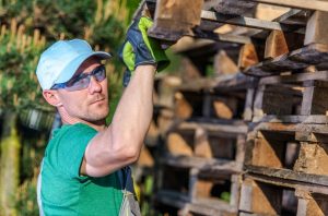 man uses safe wood pallets for home DIY