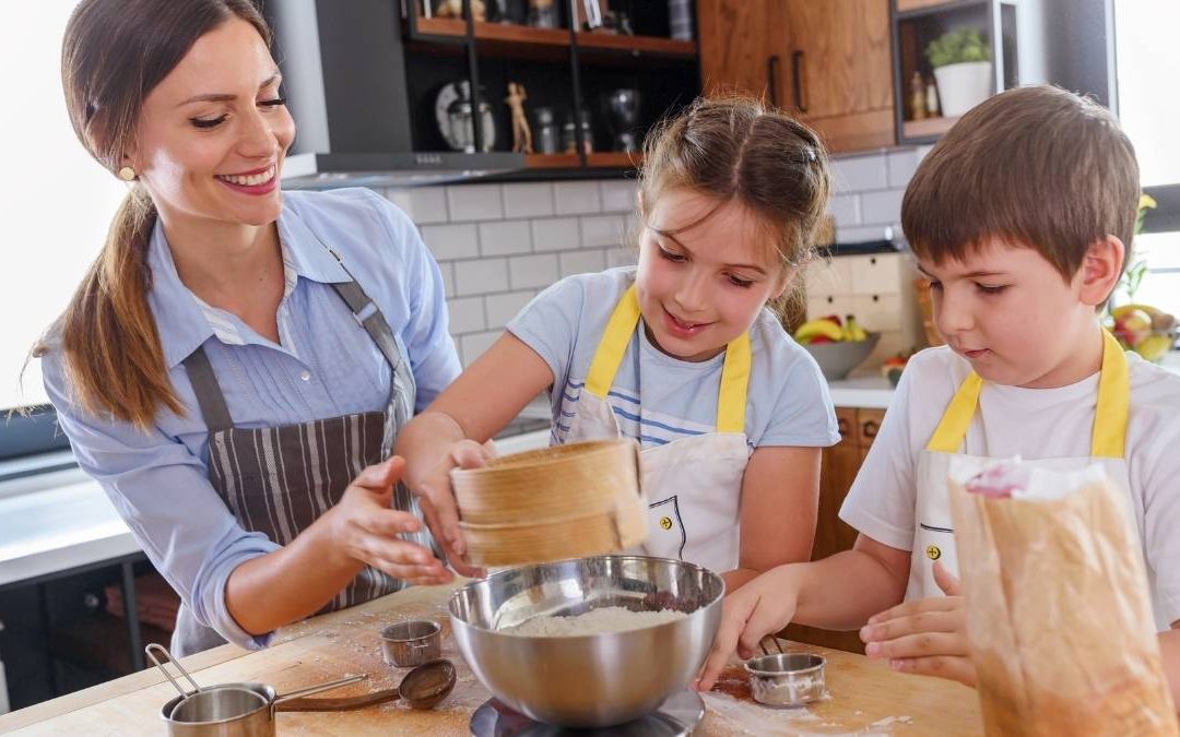 two kids are baking learning life skills teaches by mother