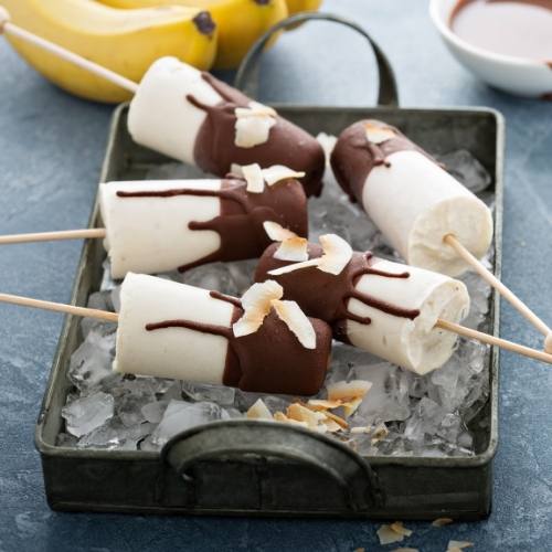 five delicious banana popsicles on-top of ice tubes