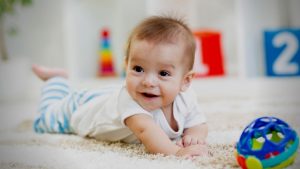 A Happy Baby In An Indoor Baby Play Area