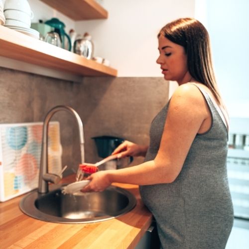 washing the dishes can be difficult with a baby bump