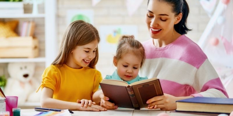 stay-at-home mom reading book with her kids