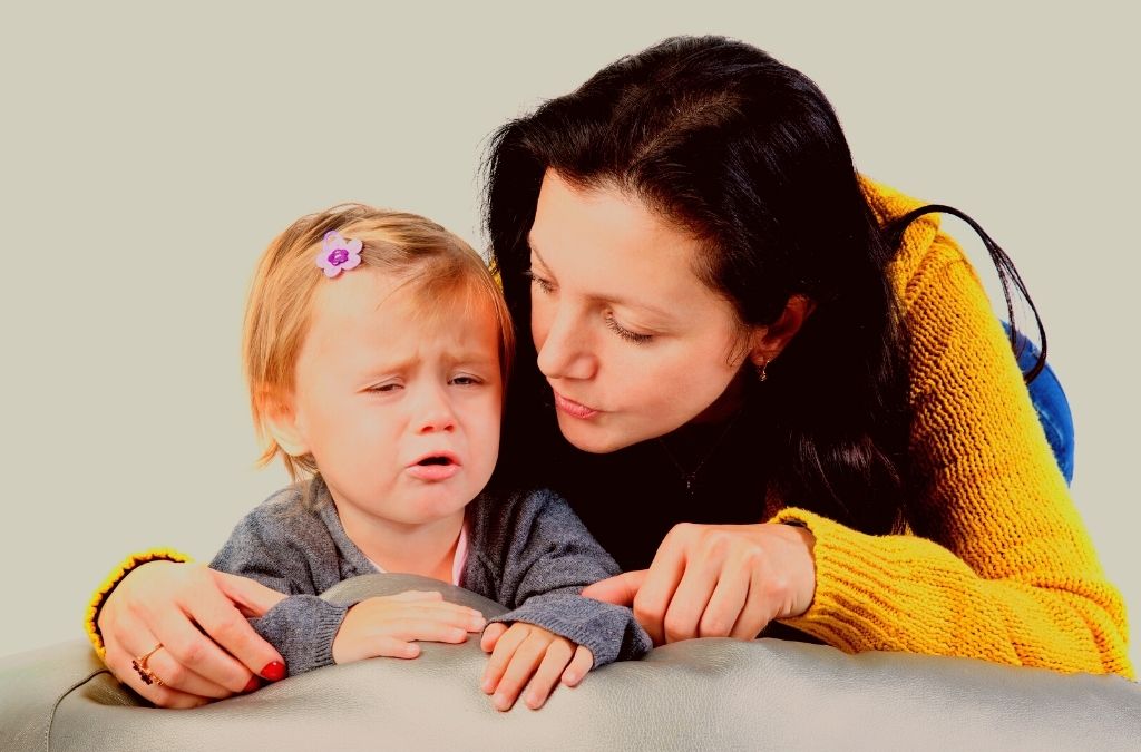mother taking to a crying child using the whisper technique and whisper method