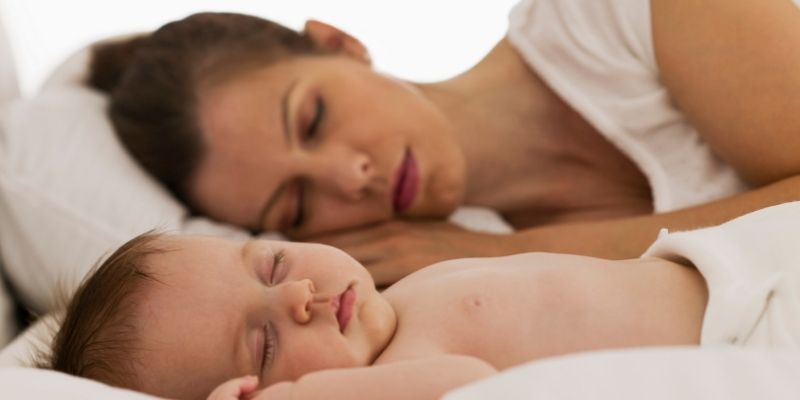 Mother is co-sleeping with the baby to enhance quality of sleep