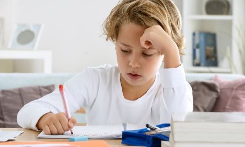 A kid do homework to balance sports and academics